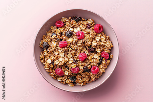 Obraz na płótnie Homemade Crunchy Granola with Fresh Raspberries and Dried Cherries in Pink Bowl on Pastel Pink Background, Top View of Healthy Breakfast, Clean Eating Food w salonie