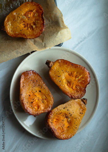 Baked multicolored carrots with parsley on a plate. View from above.