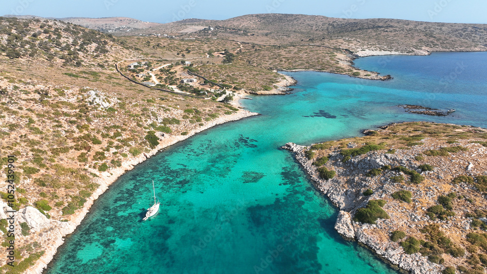 Obraz premium Aerial drone photo of yachts and sail boats anchored in tropical exotic island complex with crystal clear turquoise sea forming a blue lagoon