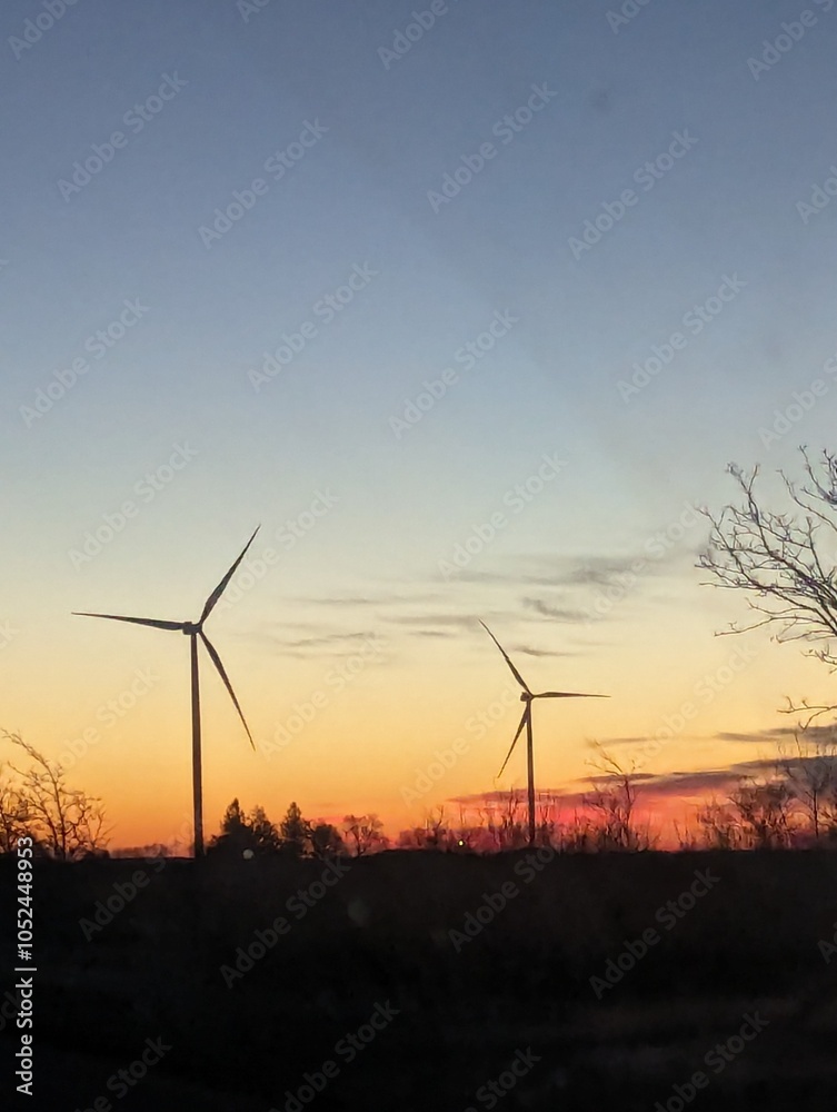 Obraz premium wind turbines at sunset