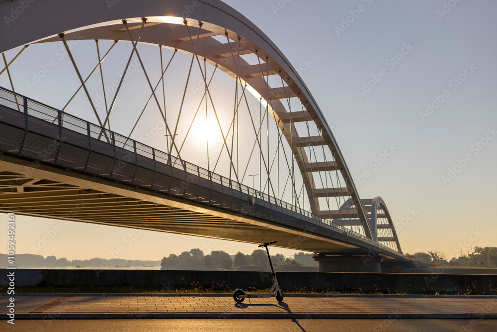 Obraz premium Electric scooter near the New Bridge in Novi Sad, Serbia