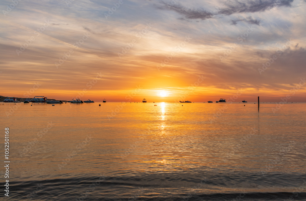 Fototapeta premium Beautiful red and orange sunrise over the sea.