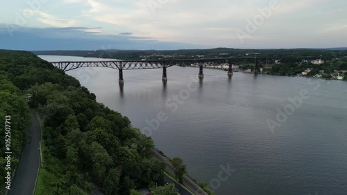 aerial footage of walkway over the hudson (railroad bridge converted to walking cycling pedestrian biking path part of empire state path and hudson valley rail trail) wide river crossing poughkeepsie