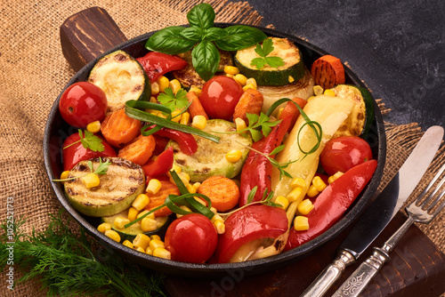 Grilled vegetables ( colorful bell pepper corn, zucchini, eggplant, onion ) on black Cast iron pan. photo