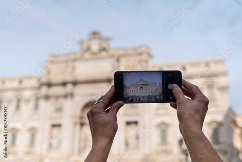 Photography Photographing the Trevi Fountain with arms raised to avoid the crowd