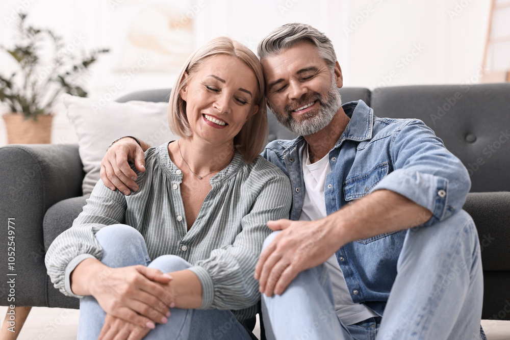 Happy middle aged couple on floor at home Happy middle aged couple on floor at home