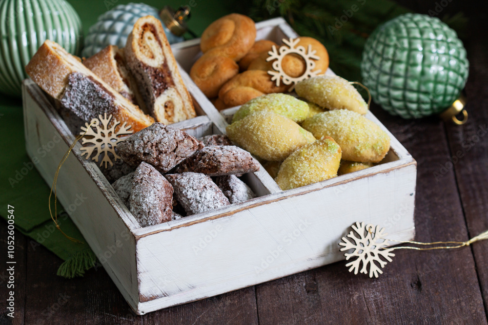 Assorted Christmas cookies with different fillings, Christmas decorations on a wooden background. Rustic style.