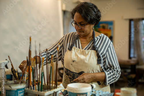 A woman creating art on her canvas. photo