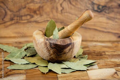 Bay leaves Laurus nobilis on olive wood photo