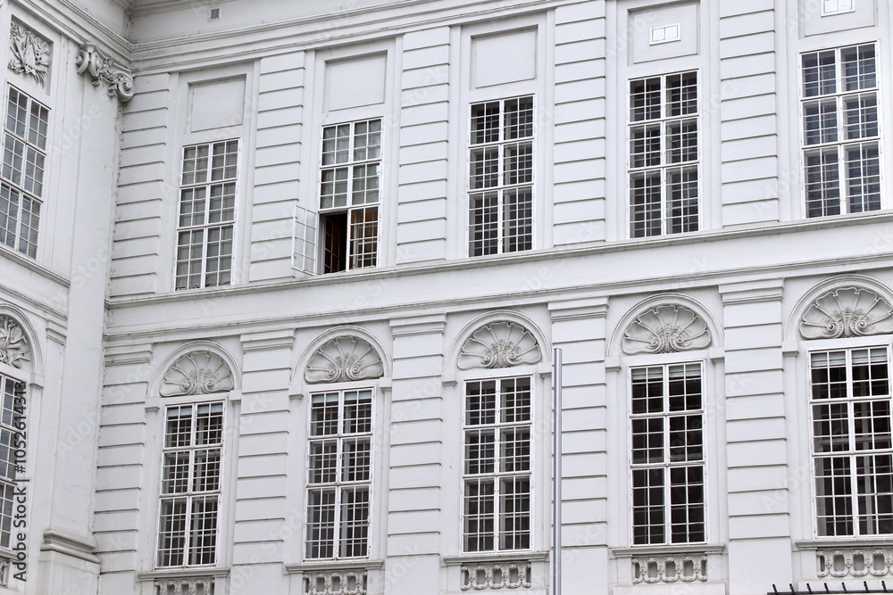 Historic White Facade with Ornate Details and Open Window, Perfect for Architecture Themes or Copy Space in Urban Travel Ads Historic White Facade with Ornate Details and Open Window, Perfect for Architecture Themes or Copy Space in Urban Travel Ads