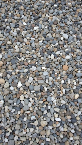 Tranquil pebble strewn path with gray white and brown stones tightly packed photo