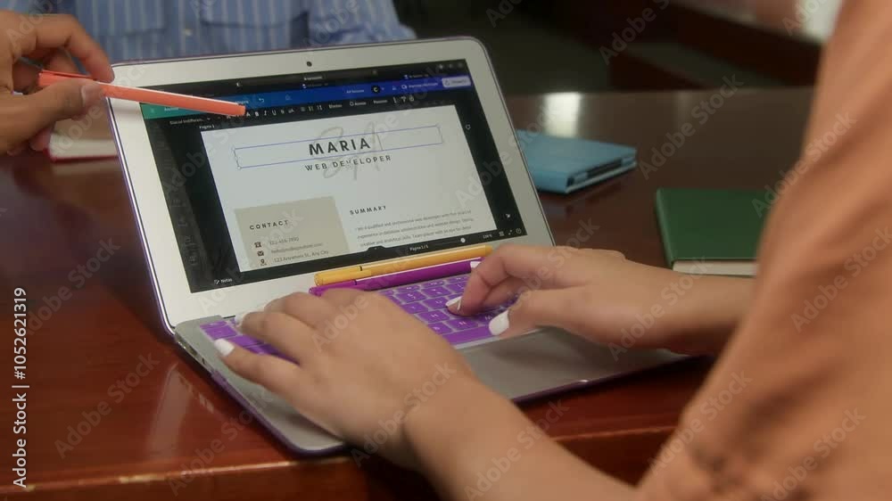 Designing a resume on a laptop screen