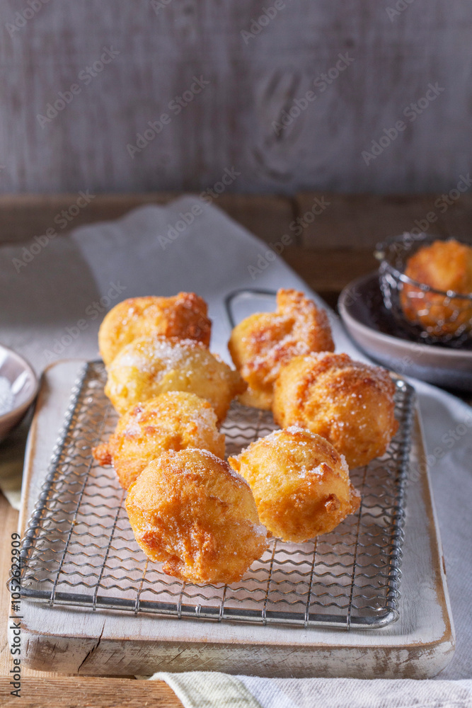 Curd donuts with sugar served with tea or coffee on a light wooden background. Rustic style.