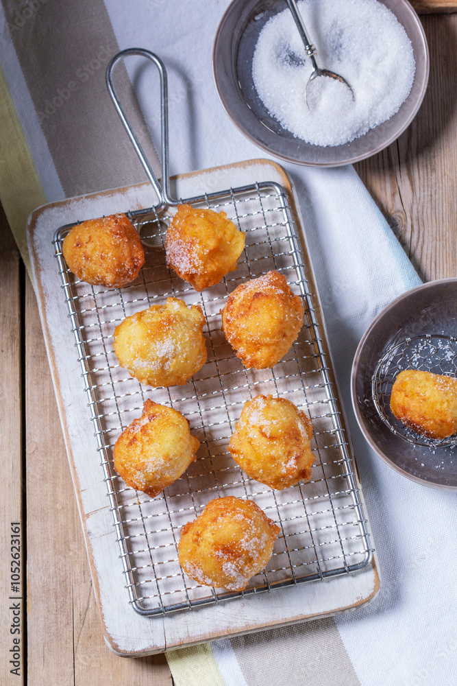 Curd donuts with sugar served with tea or coffee on a light wooden background. Rustic style.