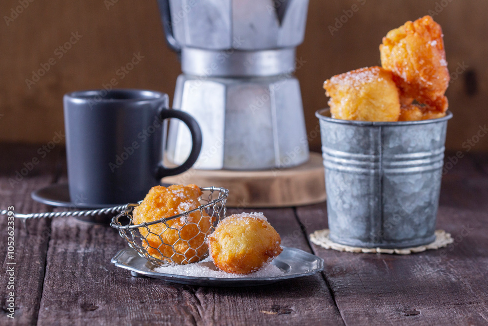 Curd donuts with sugar served with tea or coffee on a light wooden background. Rustic style.