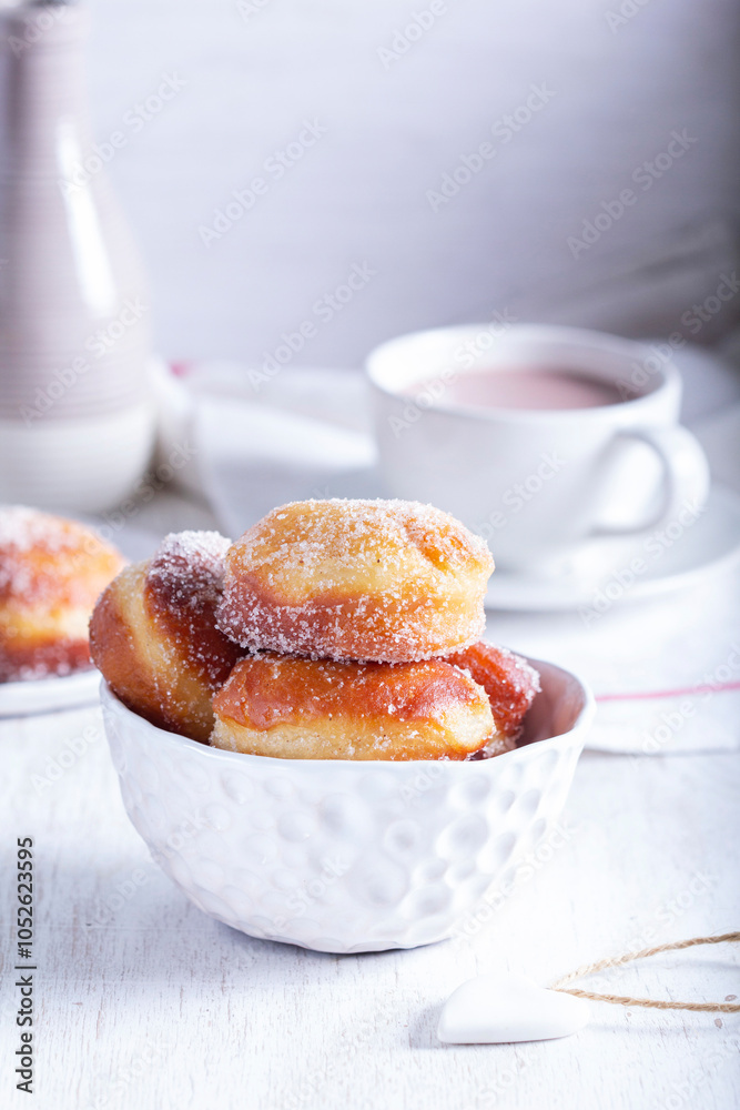 Donuts with sugar and cinnamon served with cocoa. Traditional dessert for Carnival.