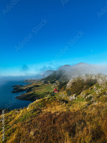 Bright blue sky and cloudy mountains over the Norwegian fjord photo