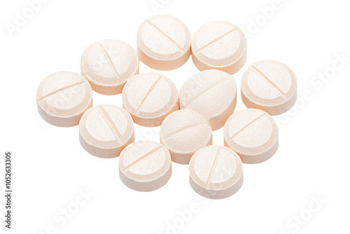 Close-up of assorted beige tablets arranged on a white background, ideal for health, medicine, and pharmaceutical themes.