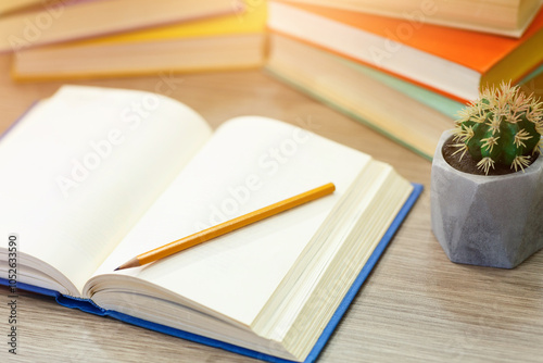 Time To Study. Open notebook lying on wooden desk with pencil on paper, high angle view