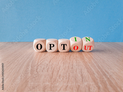 Concept words opt out and opt in on cubes. Beautiful wooden table blue background. Business concept.