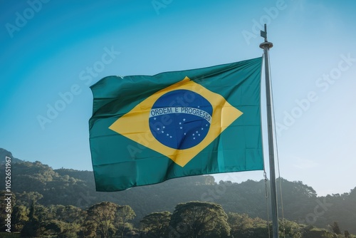 Brazilian flag waving in the wind on blue sky background photo