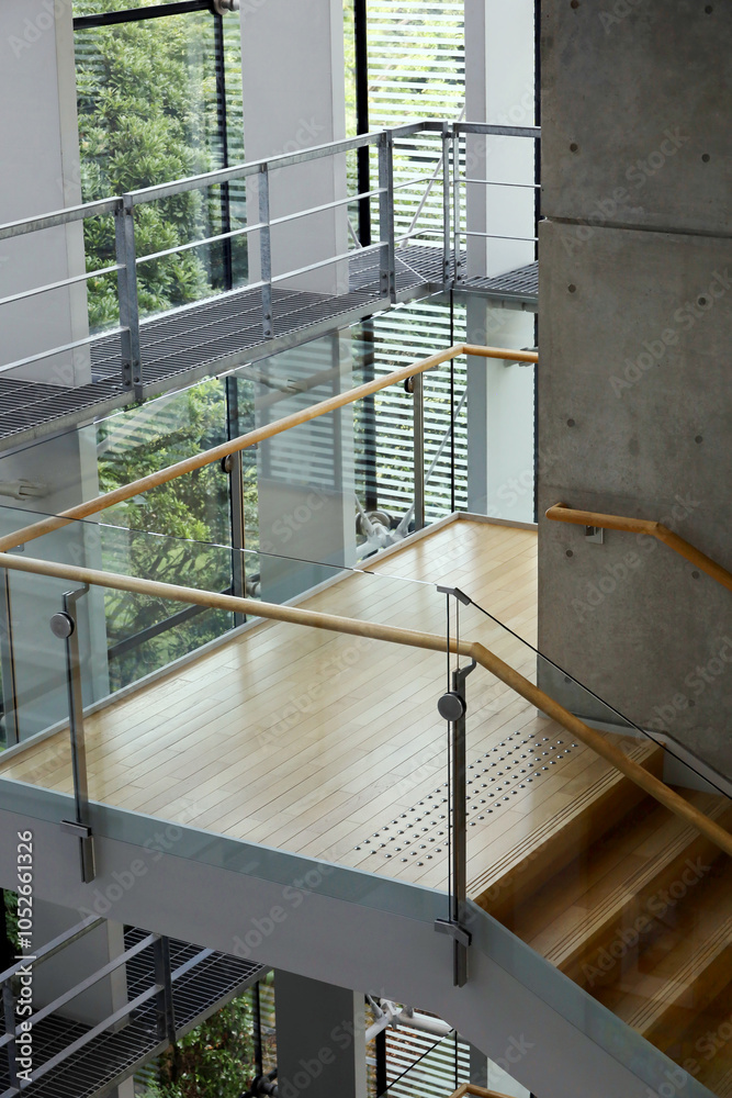 An indoor staircase made of wood, concrete, steel and glass An indoor staircase made of wood, concrete, steel and glass