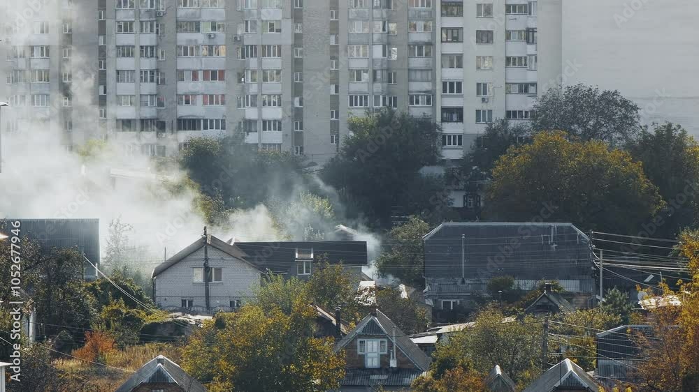 Fire in a private house. Landscape of a private sector with a house from which white smoke comes. Eastern Europe residentail area landscape. Fire in a private house. Landscape of a private sector with a house from which white smoke comes. Eastern Europe residentail area landscape.