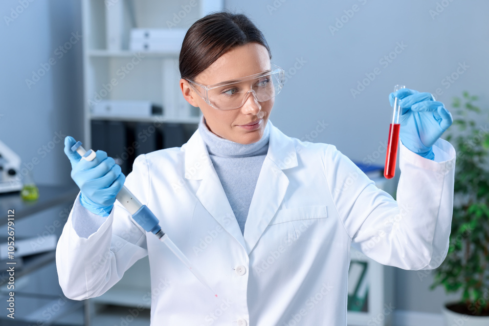 Laboratory testing. Doctor with blood sample and micropipette indoors Laboratory testing. Doctor with blood sample and micropipette indoors