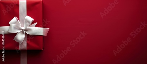 Red Gift Box With Silver Bow on Striped Red Background