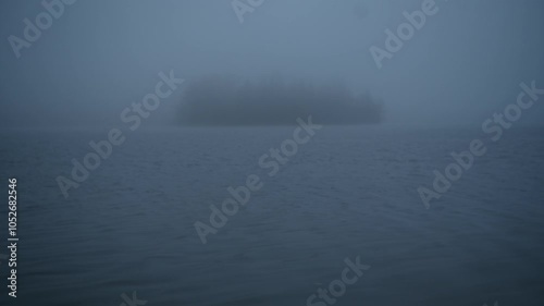 An island in the middle of a lake in autum, with a lot of fog. Schliersee