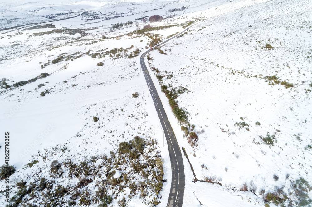 road in a snowy mountain landscape, drone aerial view. Seen from above. Background of winter concept road in a snowy mountain landscape, drone aerial view. Seen from above. Background of winter concept