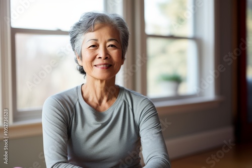 Portrait of a smiling active senior woman in sport clothes at home Free Download Portrait of a smiling active senior woman in sport clothes at home - GFXLoad