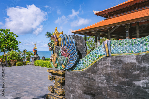Photos Traditional Balinese griffin statue overlooking the ocean with another statue an