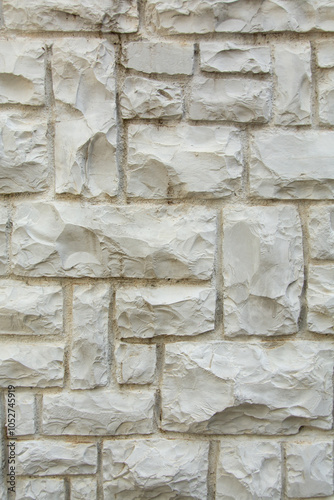 Natural marble brick wall texture background. Vertical photo.