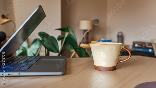 Coffee cup and laptop