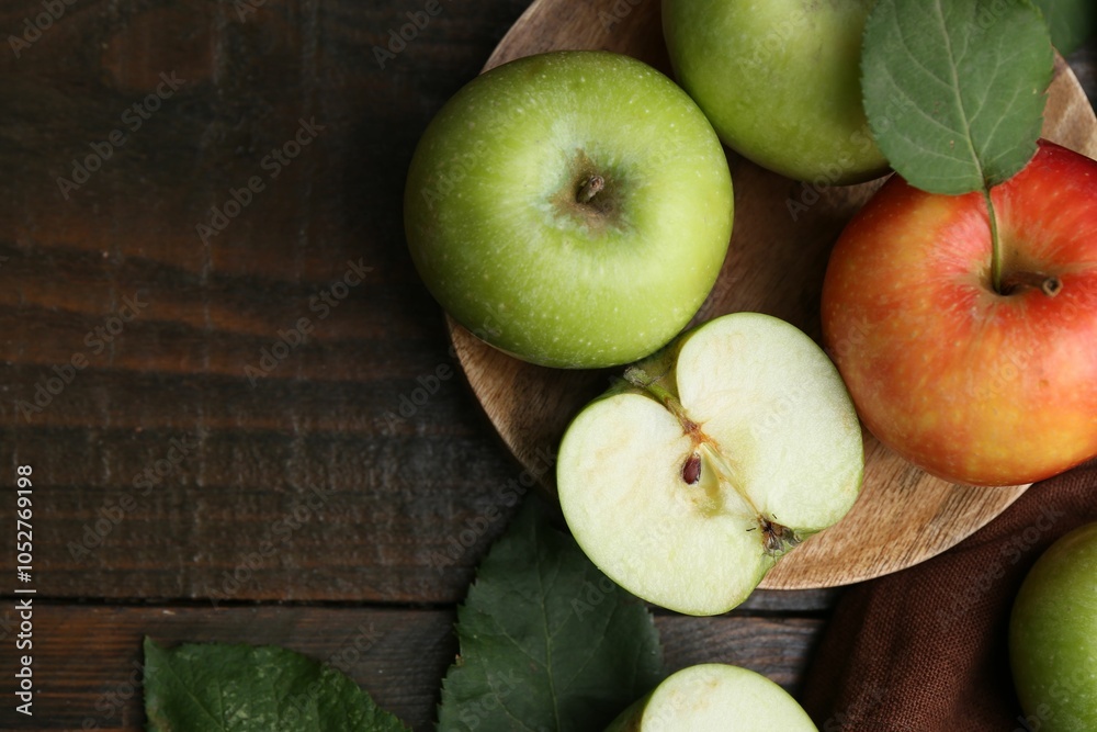Different ripe apples on wooden table, flat lay. Space for text Different ripe apples on wooden table, flat lay. Space for text
