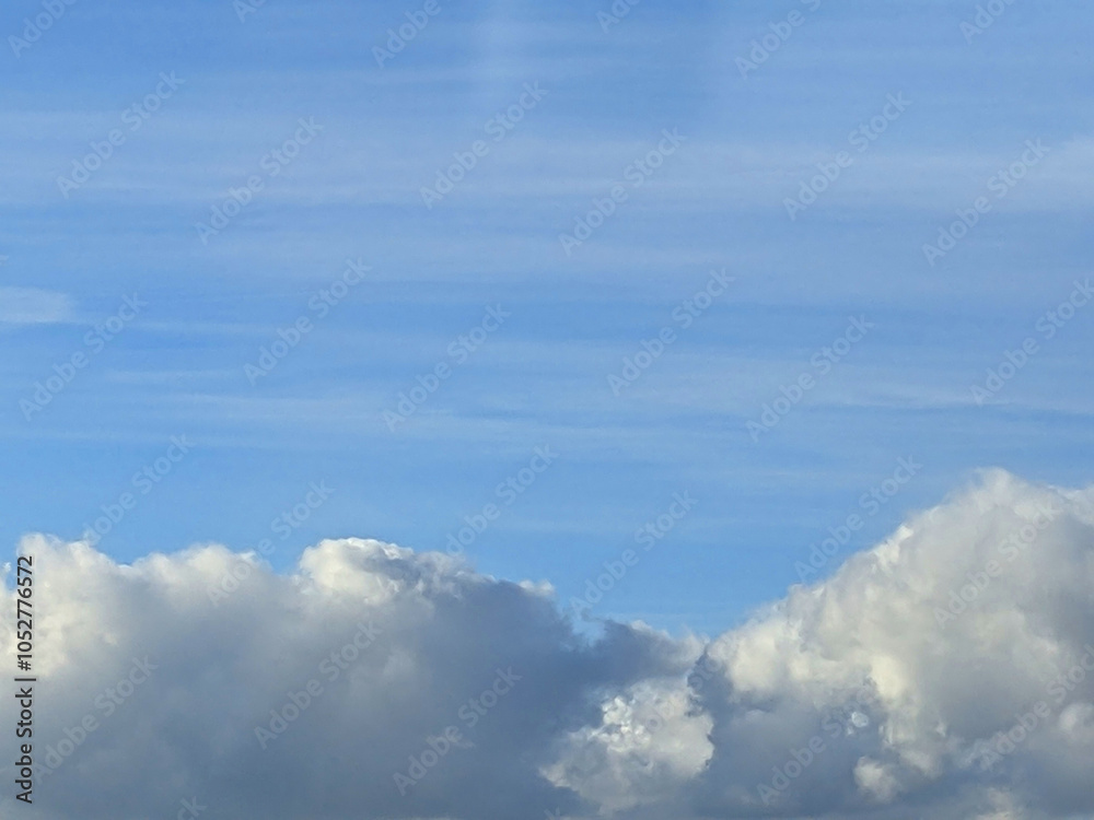 Big White Fluffy Clouds on A Blue Sky With Fine Whispy Lines Big White Fluffy Clouds on A Blue Sky With Fine Whispy Lines