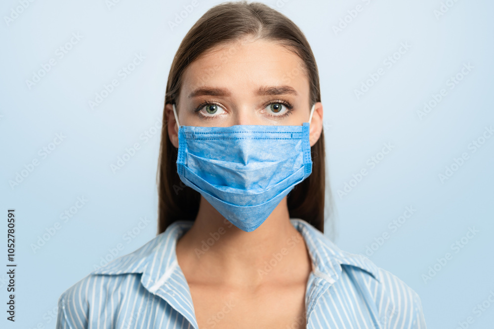 Sick Girl In Medical Mask Looking At Camera Standing Over White Studio Background. Coronavirus Protection Concept Sick Girl In Medical Mask Looking At Camera Standing Over White Studio Background. Coronavirus Protection Concept