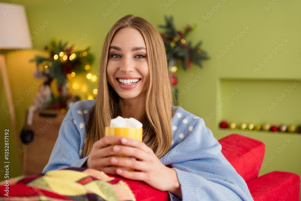 Photo of cute pretty young blonde girlfriend in ugly blue sweater enjoying cacao with marshmallow indoors home xmas atmosphere Photo of cute pretty young blonde girlfriend in ugly blue sweater enjoying cacao with marshmallow indoors home xmas atmosphere