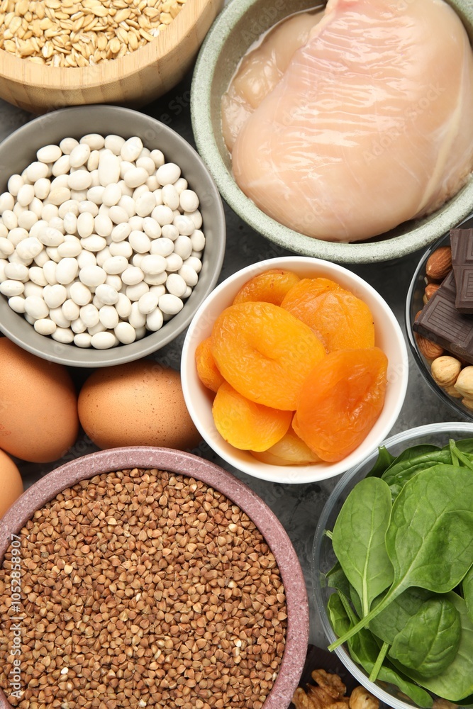 Different products rich in iron on grey table, top view. Diet plan for anemia Different products rich in iron on grey table, top view. Diet plan for anemia