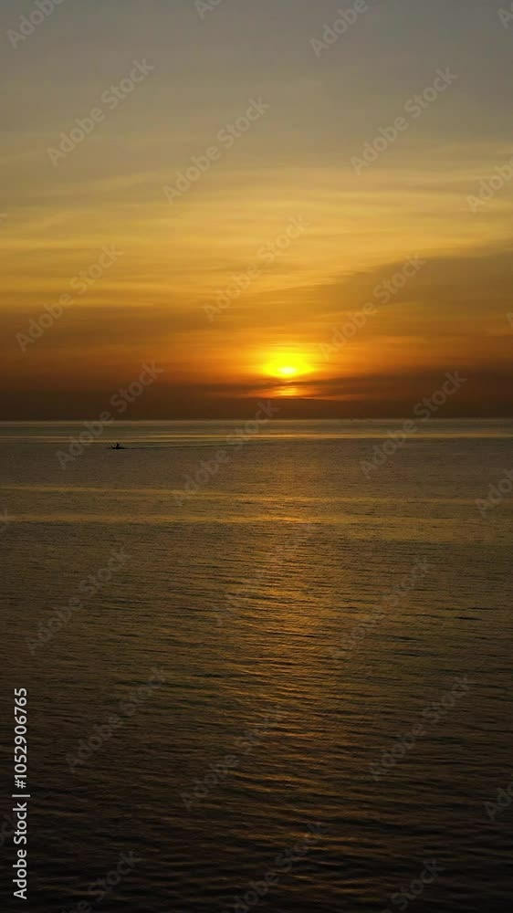Boat running over the sea with red orange sunset sky background. Bantayan Island. Madridejos, Cebu. Philippines. Vertical view. Boat running over the sea with red orange sunset sky background. Bantayan Island. Madridejos, Cebu. Philippines. Vertical view.