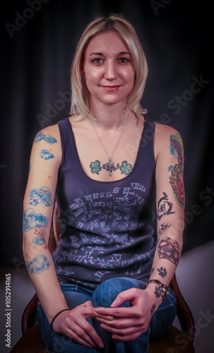 portrait of a woman in a tank top with tattoos