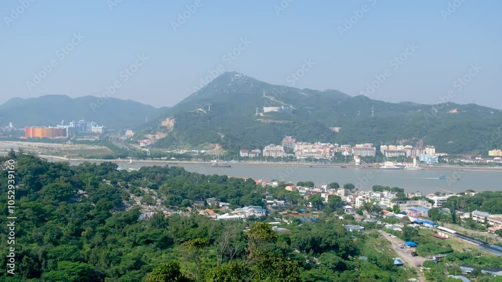 An elevated panoramic view of the urban landscape in Macao overlooks Hengqin Island, a special economic zone in Guangdong Province, China, separated from Coloane Macao by water. An elevated panoramic view of the urban landscape in Macao overlooks Hengqin Island, a special economic zone in Guangdong Province, China, separated from Coloane Macao by water.