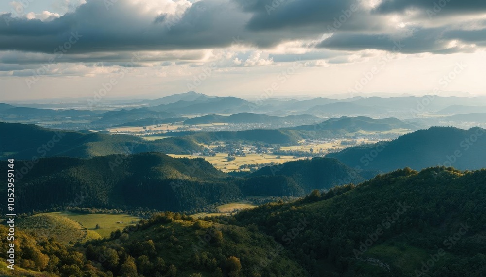mountains with a valley in the distance under a cloudy sky mountains with a valley in the distance under a cloudy sky
