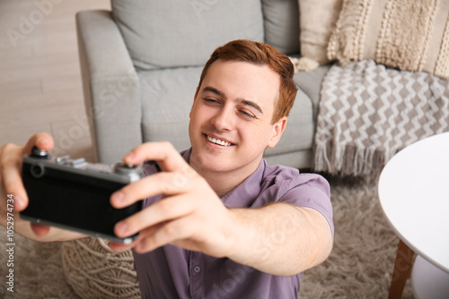 Young man with photo camera...