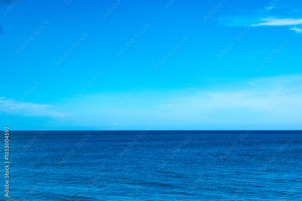 Obraz premium Nature of the beach and sea Summer with sunshine, sandy beaches, clear blue waters sparkling against the blue sky. On an island with good ecology and environment Background for summer vacation concept