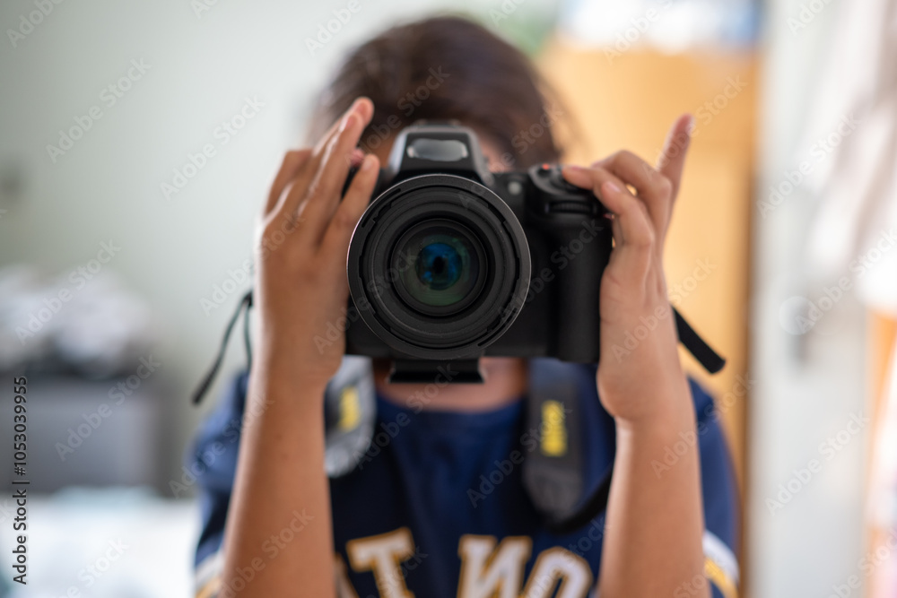 Young girl taking a photo in mirror Young girl taking a photo in mirror