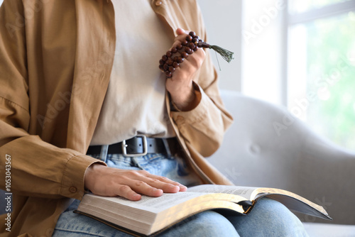 Person reading holy book wi...
