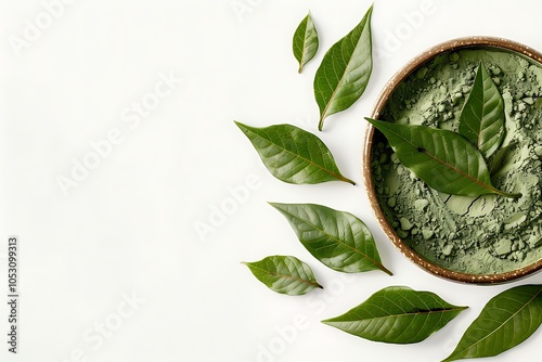 Henna powder in clay bowl with green leaves isolated on white background photo