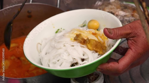 Asian street food. The process of making Vietnamese food Cao Lau this is a Vietnamese noodle bowl that includes greens, noodles, and various key ingredients. Fresh greens. photo